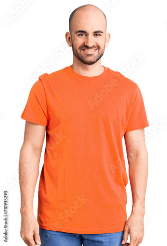 Young handsome man wering casual t shirt with a happy and cool smile on face. lucky person.