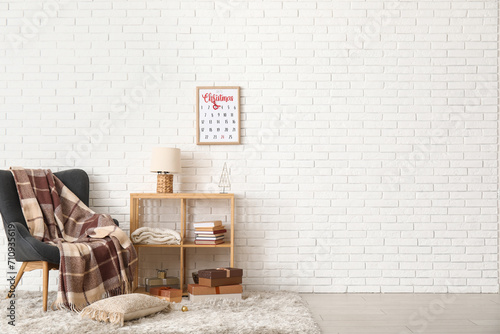 Interior of living room with Christmas calendar, armchair and shelf unit photo