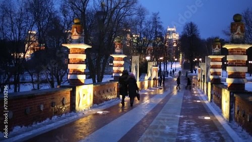 People walk on Large (Gothic) bridge near Tsaritsyno Palace  photo