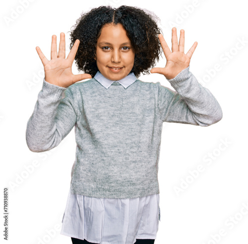 Young little girl with afro hair wearing casual clothes showing and pointing up with fingers number ten while smiling confident and happy. © Krakenimages.com