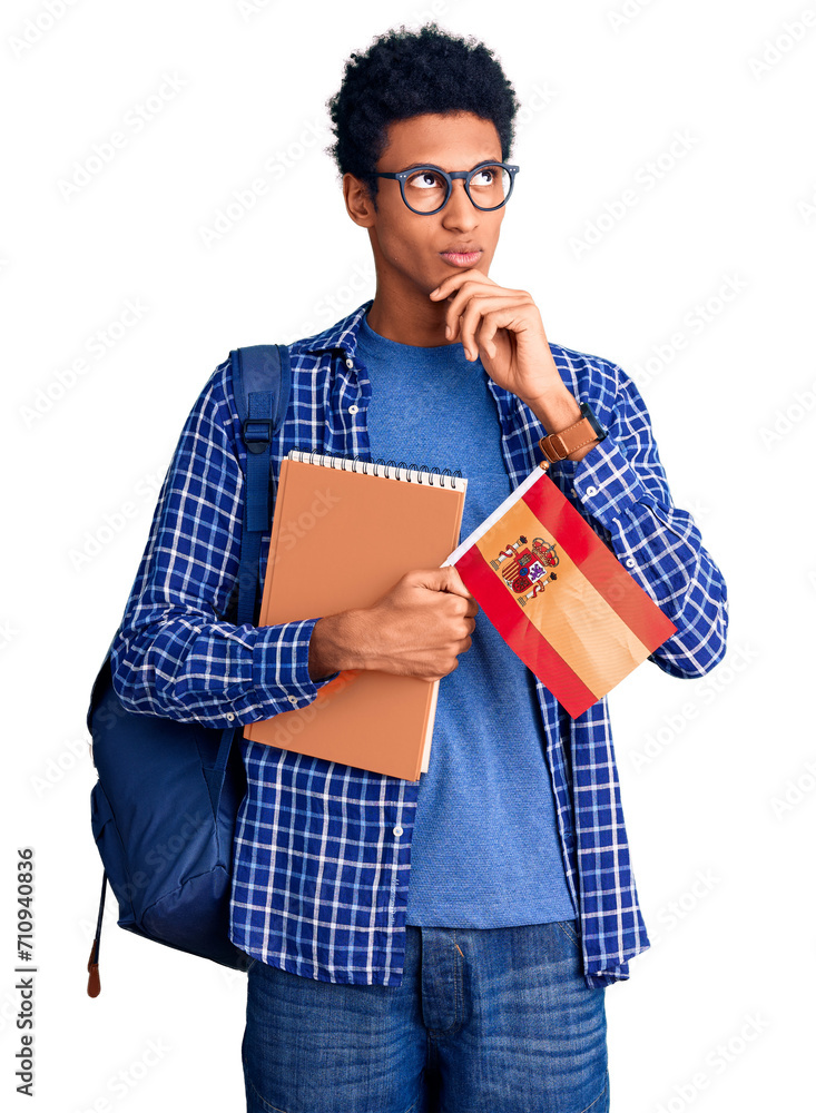 Young african american man wearing student backpack holding spanish flag serious face thinking about question with hand on chin, thoughtful about confusing idea Young african american man wearing student backpack holding spanish flag serious face thinking about question with hand on chin, thoughtful about confusing idea
