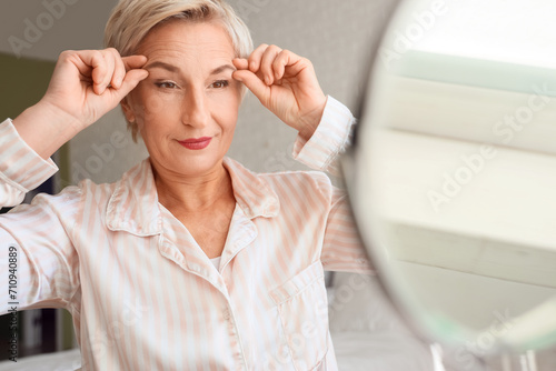 Mature woman doing face bui...