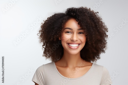 Young smiling african american woman on white background © Alina