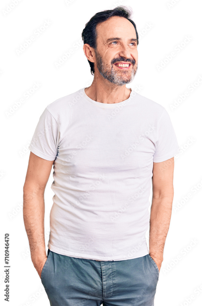 Middle age handsome man wearing casual t-shirt looking away to side with smile on face, natural expression. laughing confident. Middle age handsome man wearing casual t-shirt looking away to side with smile on face, natural expression. laughing confident.