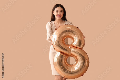 Smiling young woman holding...