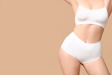Body positive woman in underwear on beige background, closeup