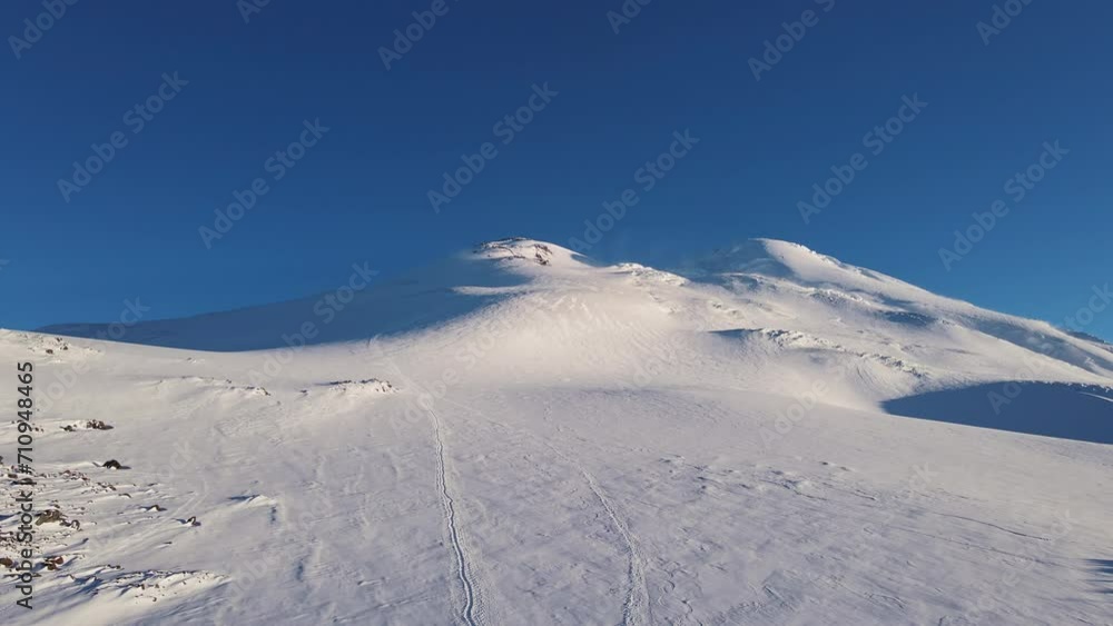 Elbrus in snow Europe's highest peak Elbrus symbol of untouched mountain beauty. Elbrus majestic giant in realm of high mountains Crowned with snow it whispers tales of time and nature's might. Elbrus in snow Europe's highest peak Elbrus symbol of untouched mountain beauty. Elbrus majestic giant in realm of high mountains Crowned with snow it whispers tales of time and nature's might.