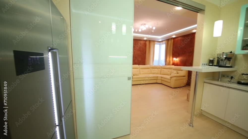 Beautiful modern kitchen overlooking living room with sofa Beautiful modern kitchen overlooking living room with sofa