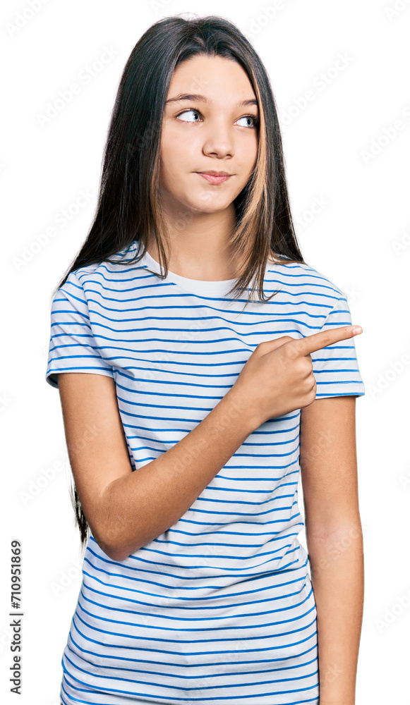 Young brunette girl with long hair pointing with fingers to the side smiling looking to the side and staring away thinking. Young brunette girl with long hair pointing with fingers to the side smiling looking to the side and staring away thinking.