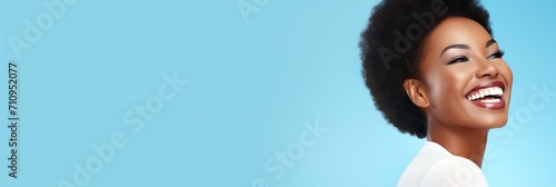 banner with a young african happy girl portrait and place for text on a blue background. concept banner, poster, asian, smile photo