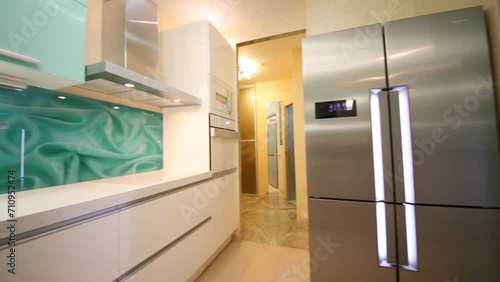 kitchen with two-folding refrigerator and furniture in apartment photo