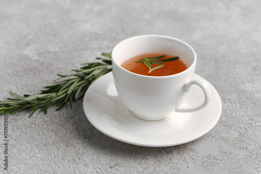 Cup of hot rosemary tea on grey background Cup of hot rosemary tea on grey background