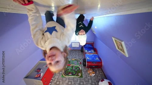 Little girl and boy crawl on ceiling upside down at inverted house 