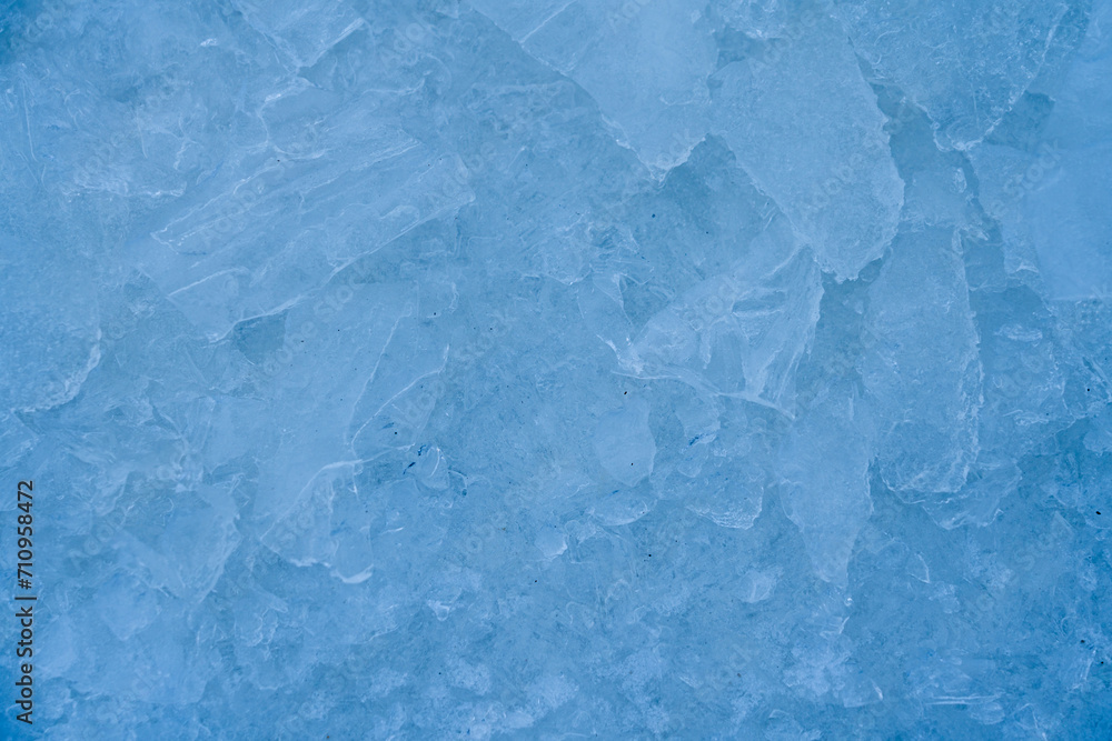 Obraz premium Icy winter background cracked grunge texture. Natural scratched ice on a skating rink as a texture or background for a winter composition, large long painting