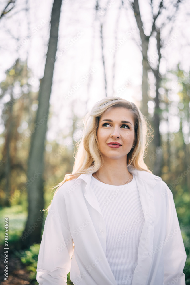Portrait of young woman walking in spring forest. Portrait of young woman walking in spring forest.
