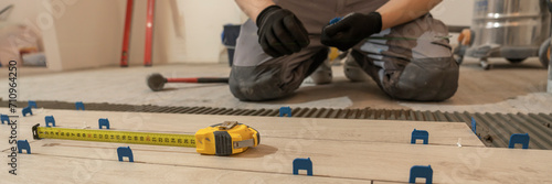 Repair and construction. Laying ceramic tiles using cement on the floor close-up. A man lays slabs on the floor and walls.