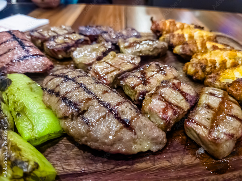 grilled meat and vegetables on a wooden board in the restaurant grilled meat and vegetables on a wooden board in the restaurant