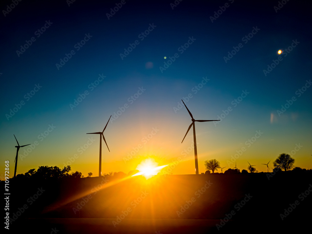 Obraz premium Wind turbines at sunset, alternative energy source. Alternative energy concept