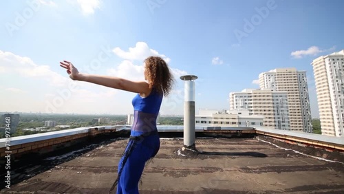 Young woman in blue costume dances belly dance photo