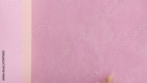Hands of colourer with brush working in new pink room photo