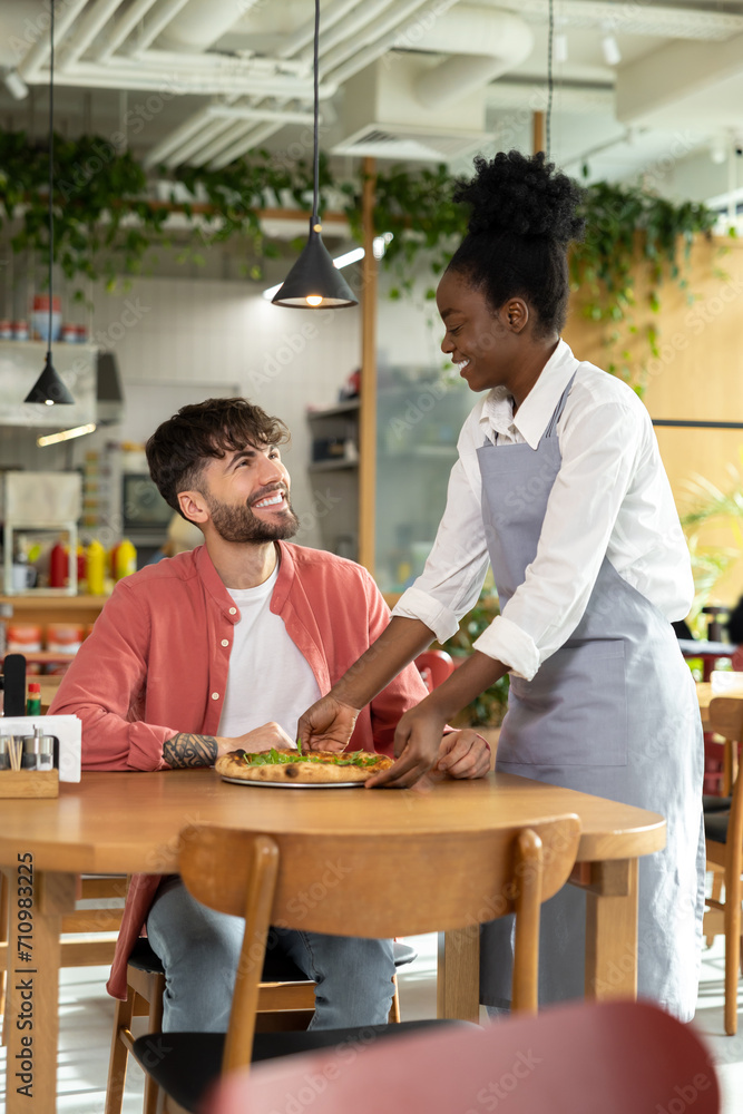 African american waitress taking order from customer in a cafe African american waitress taking order from customer in a cafe