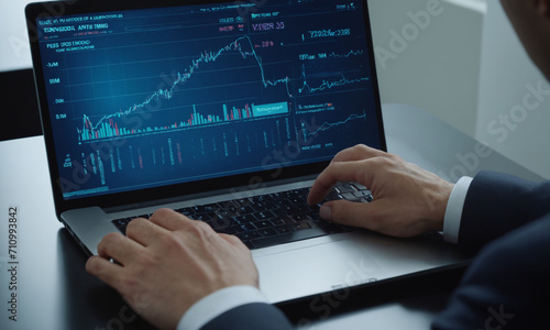 Man's hands on the laptop working with charts. Investments and trading charts 