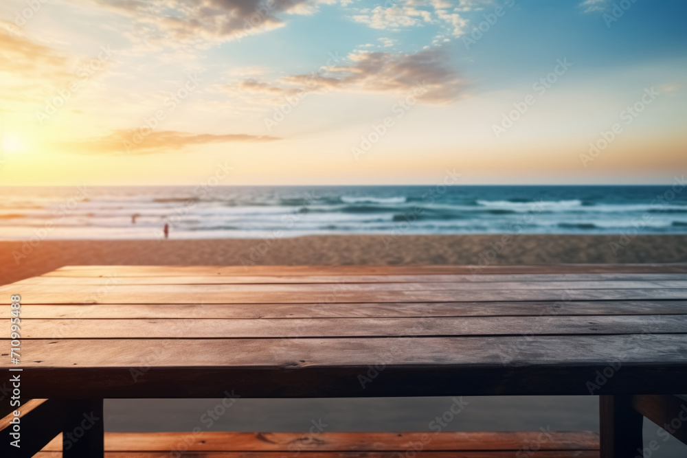 Empty wooden table outdoor in sunset rays with ocean on blurred background