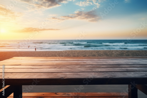 Empty wooden table outdoor in sunset rays with ocean on blurred background © Balica