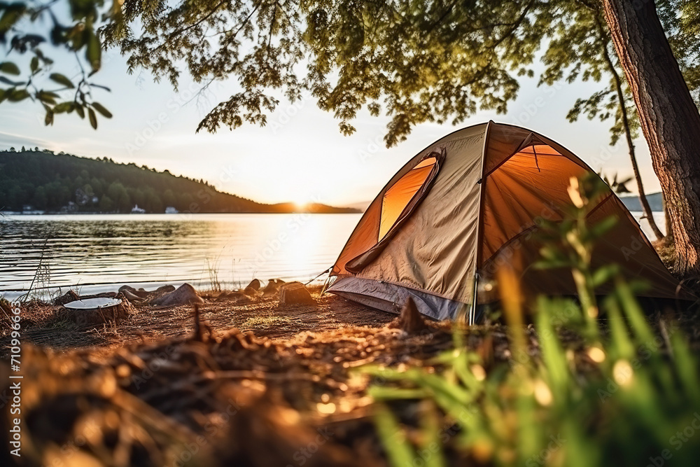 Tent on the bank of a river, lake at sunset, dawn. Camping. Generated by artificial intelligence