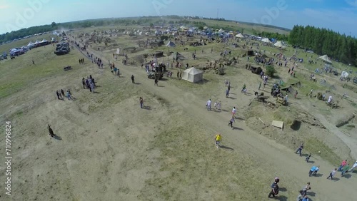 Tourists walk by military camp during reconstruction Battlefield photo