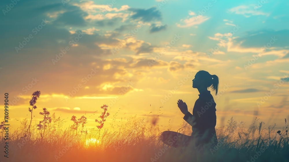 Silhouette of woman kneeling down praying for worship God at sky background. Christians pray to jesus christ for calmness. In morning people got to a quiet place and prayed. copy space