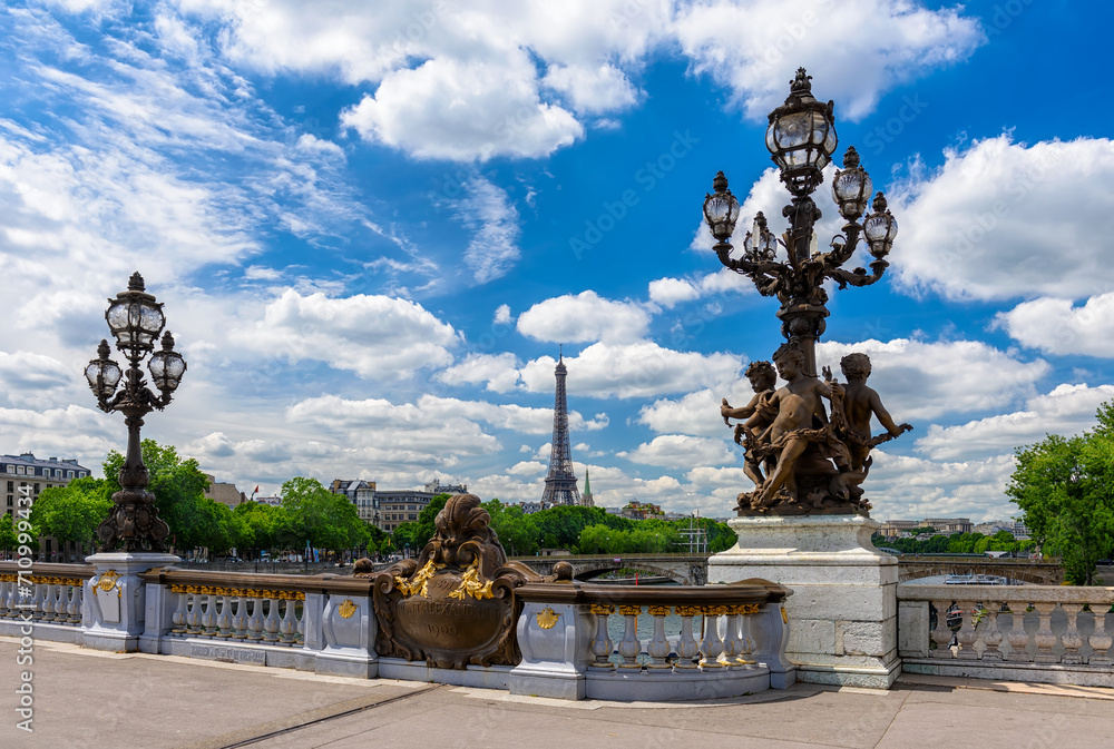 Street lantern on the Alexandre III Bridge with the Eiffel Tower in the background in Paris, France. Eiffel Tower is one of the most iconic landmarks of Paris. Cityscape of Paris