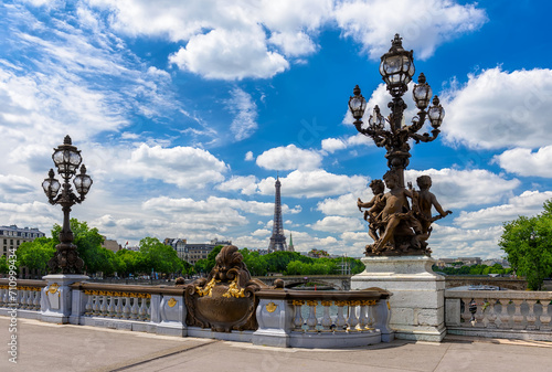 Street lantern on the Alexandre III Bridge with the Eiffel Tower in the background in Paris, France. Eiffel Tower is one of the most iconic landmarks of Paris. Cityscape of Paris