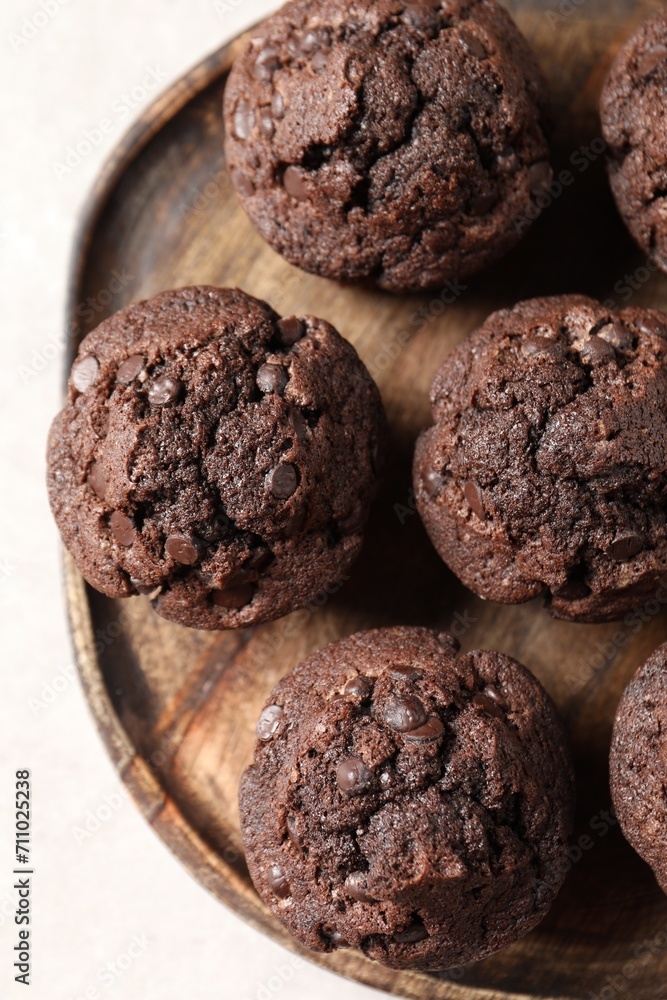 Board with delicious chocolate muffins on white table, top view Board with delicious chocolate muffins on white table, top view