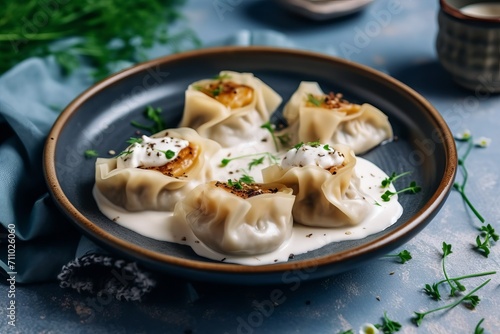 Dumplings in a plate on a green background. Concept: food made from dough is steamed. Calorie-rich food made from flour. Banner with copy space