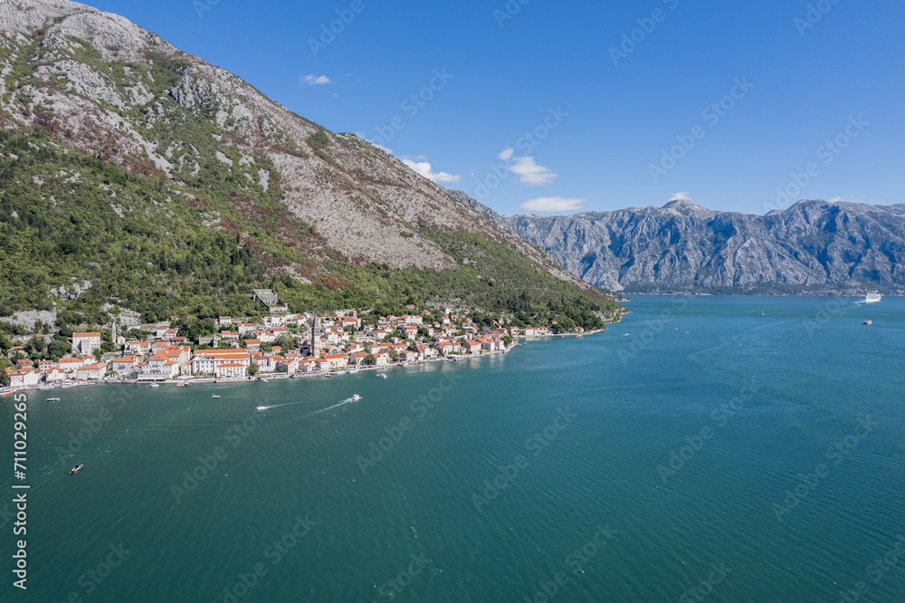 Drone view of the resort town on the shores of the Bay of Kotor at the foot of the mountains. Montenegro