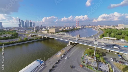 Megalopolis with traffic on river bridge and skyscrapers photo