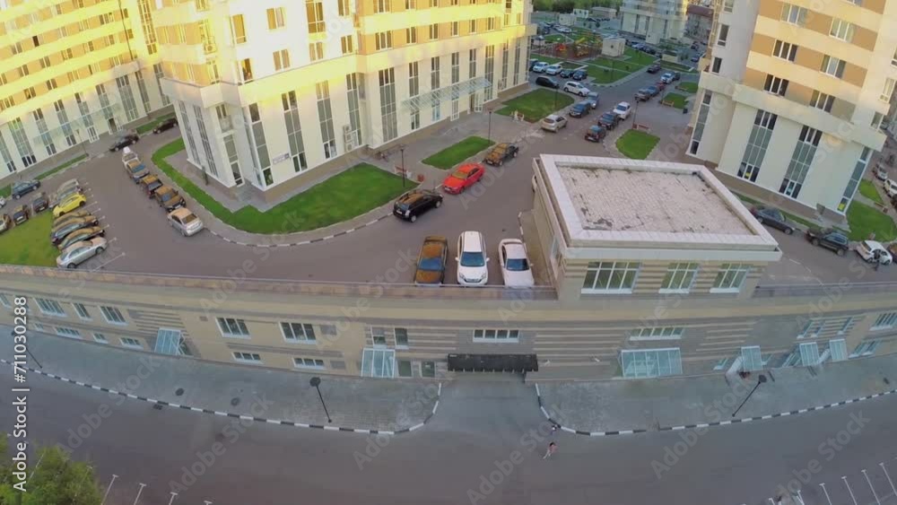 Car parking on yard near dwelling complex at summer evening Car parking on yard near dwelling complex at summer evening