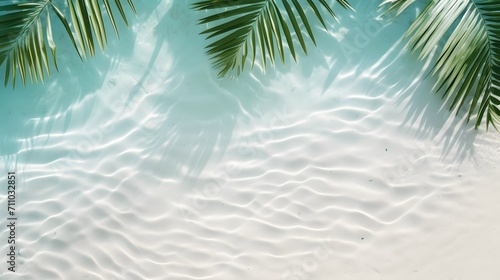top view of water surface with tropical leaf shadow. Shadow of palm leaves on white sand beach. Beautiful abstract background concept banner for summer vacation at the beach.  © Ziyan Yang