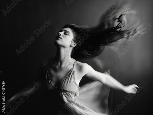 Black and white portrait of a beautiful young woman with flying hair.