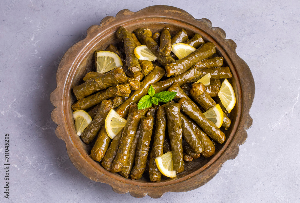 Delicious dolma (sarma) stuffed grape leaves rice. Lebanese dolma sarma on plate. Lebanon turkish greek middle eastern cuisine. (Turkish name; Yaprak sarma)