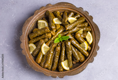 Obraz na płótnie Delicious dolma (sarma) stuffed grape leaves rice. Lebanese dolma sarma on plate. Lebanon turkish greek middle eastern cuisine. (Turkish name; Yaprak sarma) w salonie