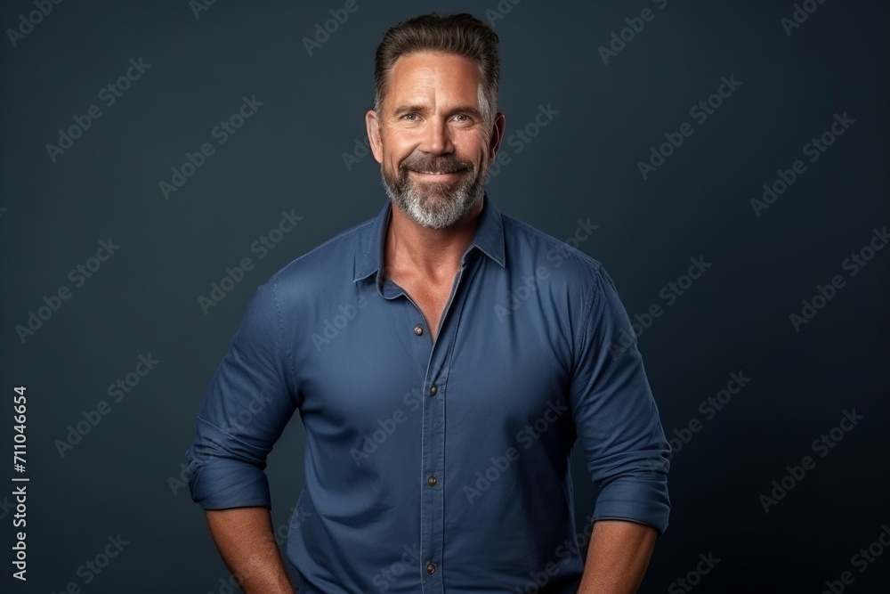 Portrait of a handsome middle-aged man wearing a blue shirt. Portrait of a handsome middle-aged man wearing a blue shirt.