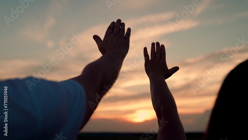 Man and woman raise their hands to sunny sky. Religion and faith teamwork. Man woman couple stretches their hands up to sun. Adventures, travel. Group of friends, teamwork. Prayer sunset, faith in God