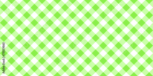 Gingham or vichy pattern with diagonal green and white squares. Checkered background. Spring or summer tablecloth, napkin, towel, handkerchief texture. Wrapping paper print. Picnic plaid design.