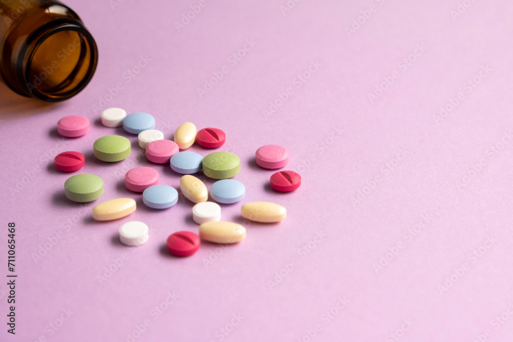 Pills and pill bottles on lilac background. Top view. Flat lay. Copy space. Medicine concept Pills and pill bottles on lilac background. Top view. Flat lay. Copy space. Medicine concept
