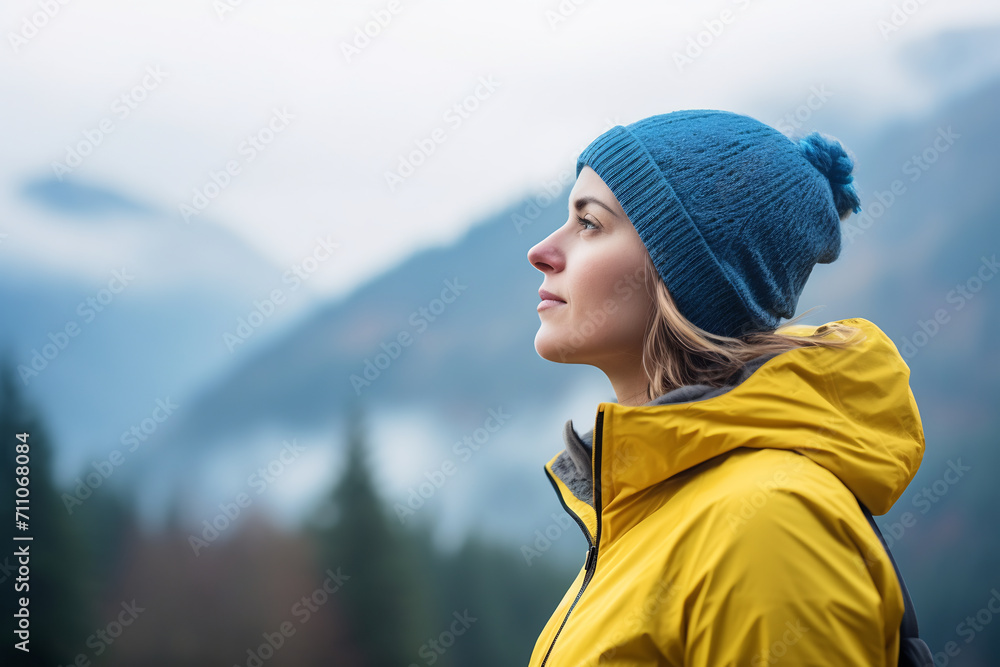 Serene Young Woman Hiker in Yellow Beanie Enjoying the Serene Mountain View, Mindfulness and Outdoor Adventure in Nature Concept Serene Young Woman Hiker in Yellow Beanie Enjoying the Serene Mountain View, Mindfulness and Outdoor Adventure in Nature Concept