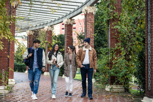 group of four student friends returning from university