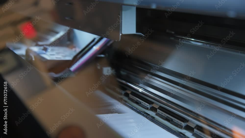 Printing on film on a large technological printer, Production of advertising films. Wide shot footage Printing on film on a large technological printer, Production of advertising films. Wide shot footage