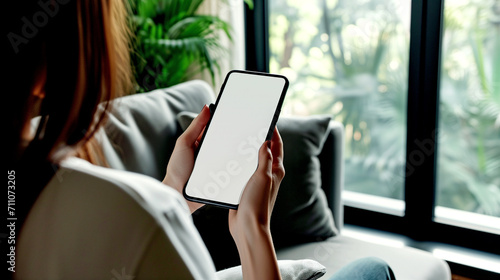Woman Holding Smartphone with Blank White Screen	